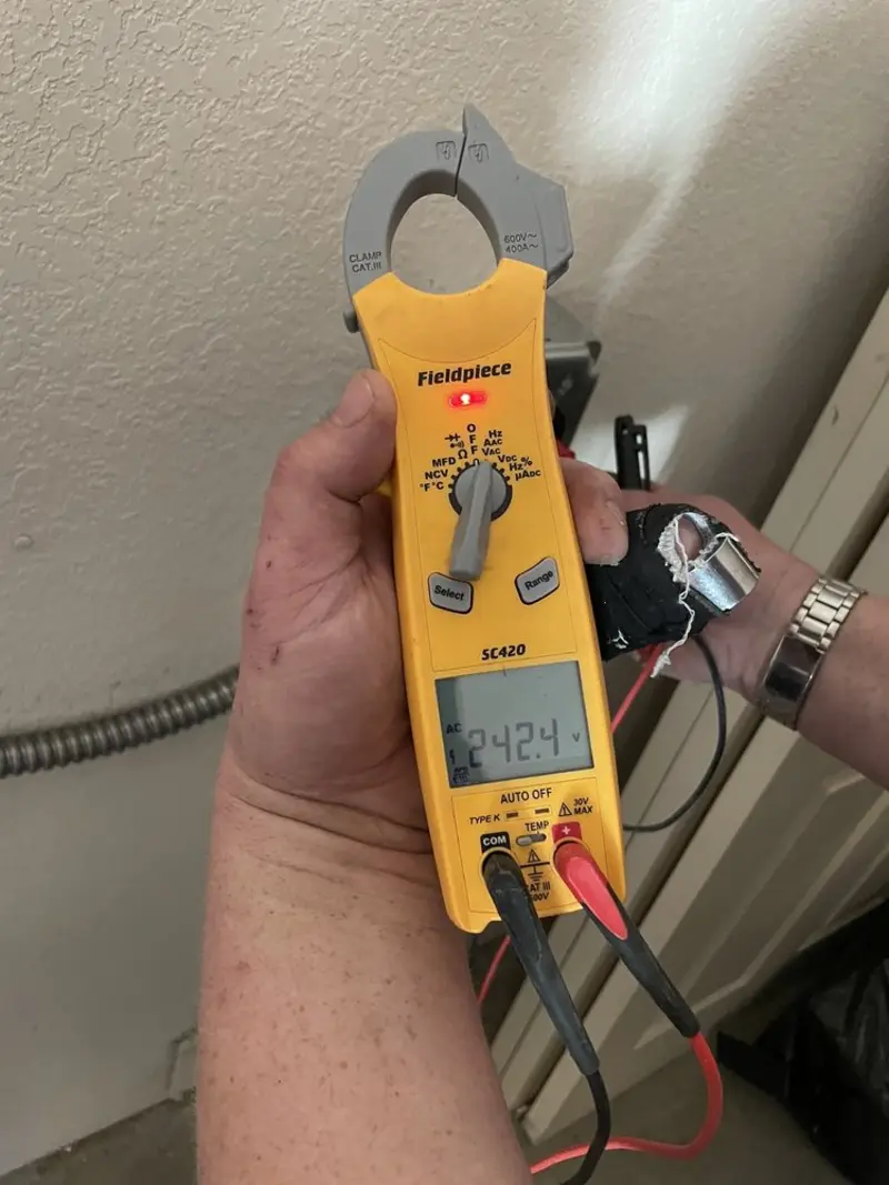 Voltage testing with clamp meter during Recessed Lighting Installation in Monroe